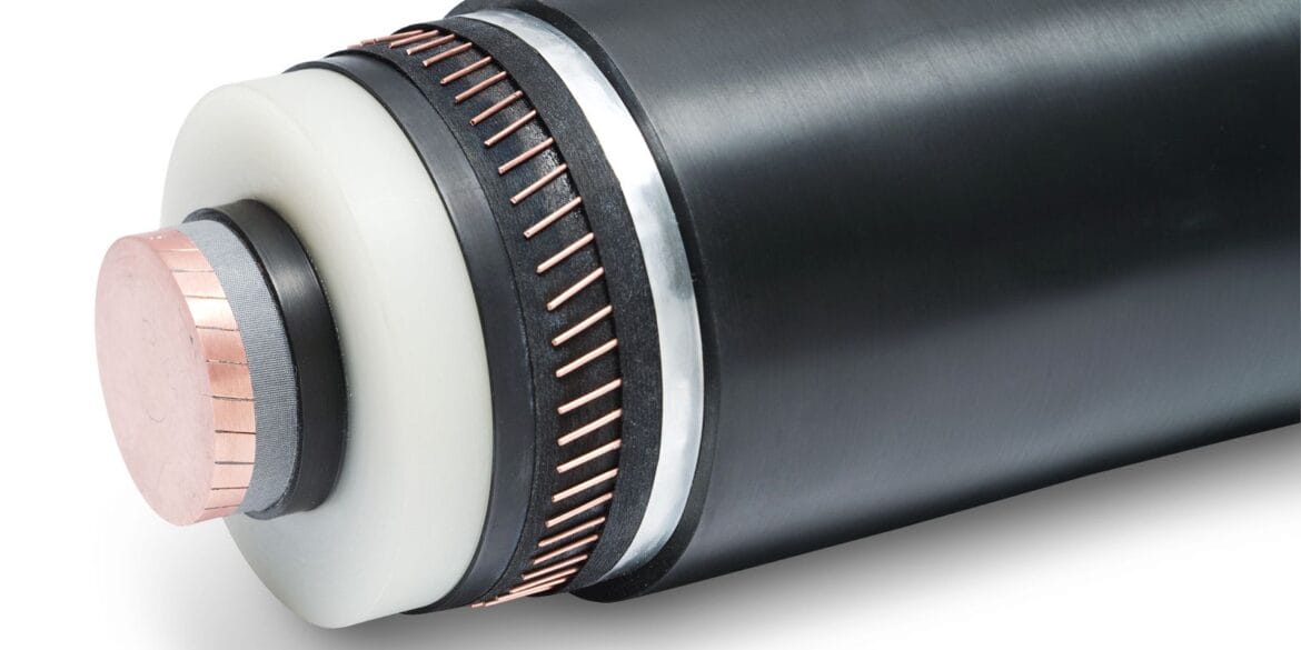 Close-up of a high-voltage power cable, showing layers of insulation, copper conductors, and outer black sheath.